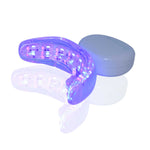 The Cozy Smile Kit red and blue light therapy oral care mouthpiece turned on, white background.