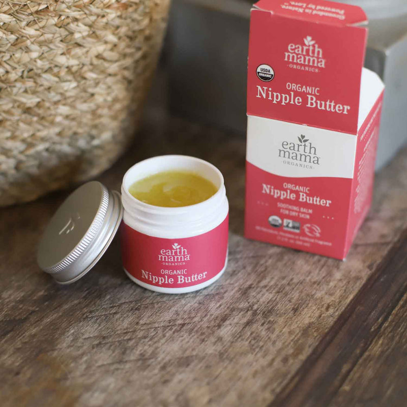 earth mama organic  nipple butter can and box on wood table
